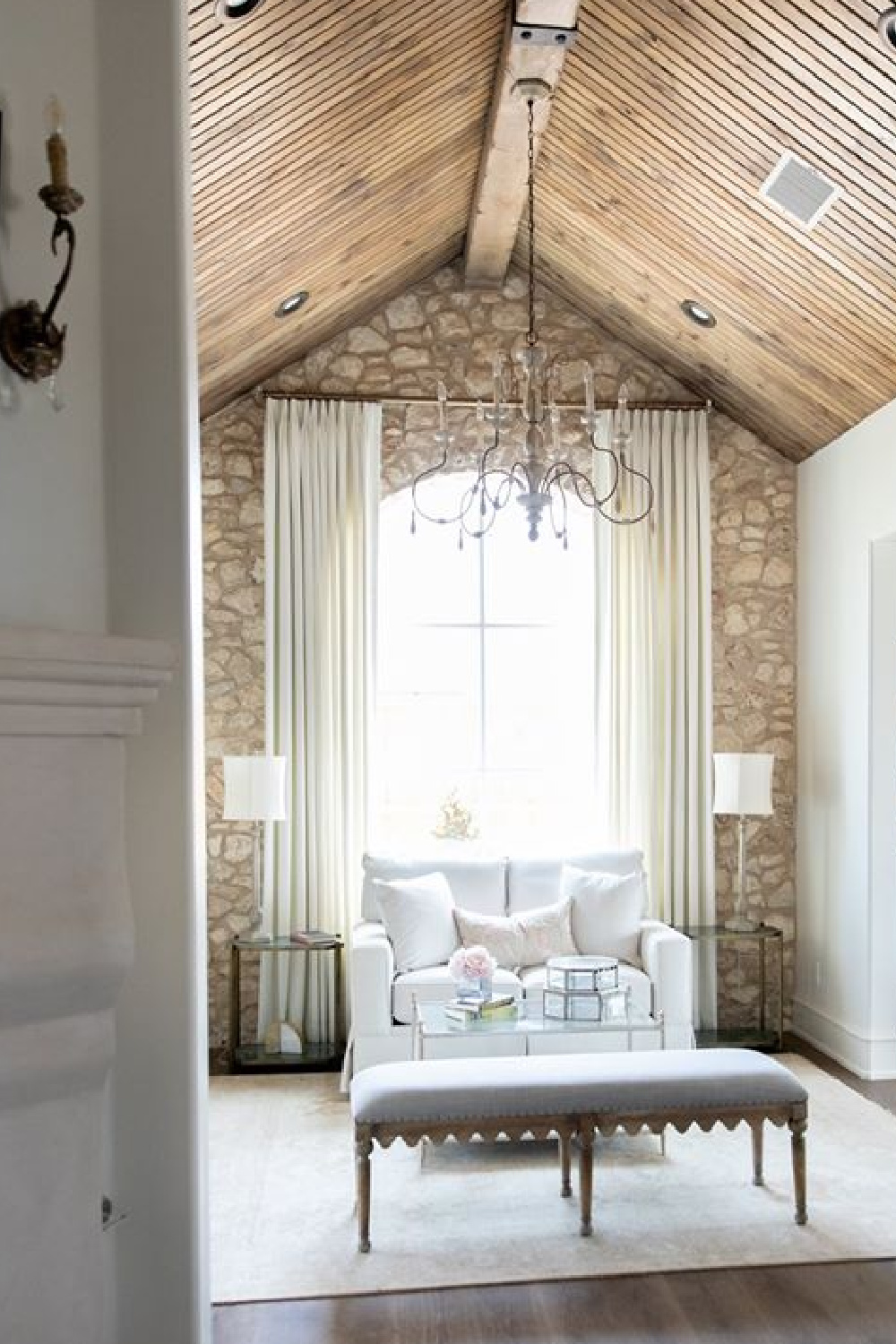 Stone statement wall in a French country bedroom sitting area - Brit Jones.