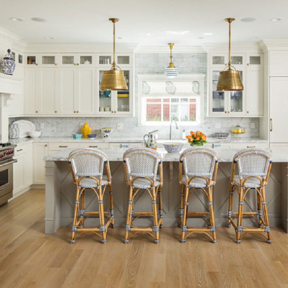 Parisian counter stools in a classic white kitchen with blue accents by The Fox Group. #kitchendesign #timeless #parisian #counterstool #whitekitchen #thefoxgroup