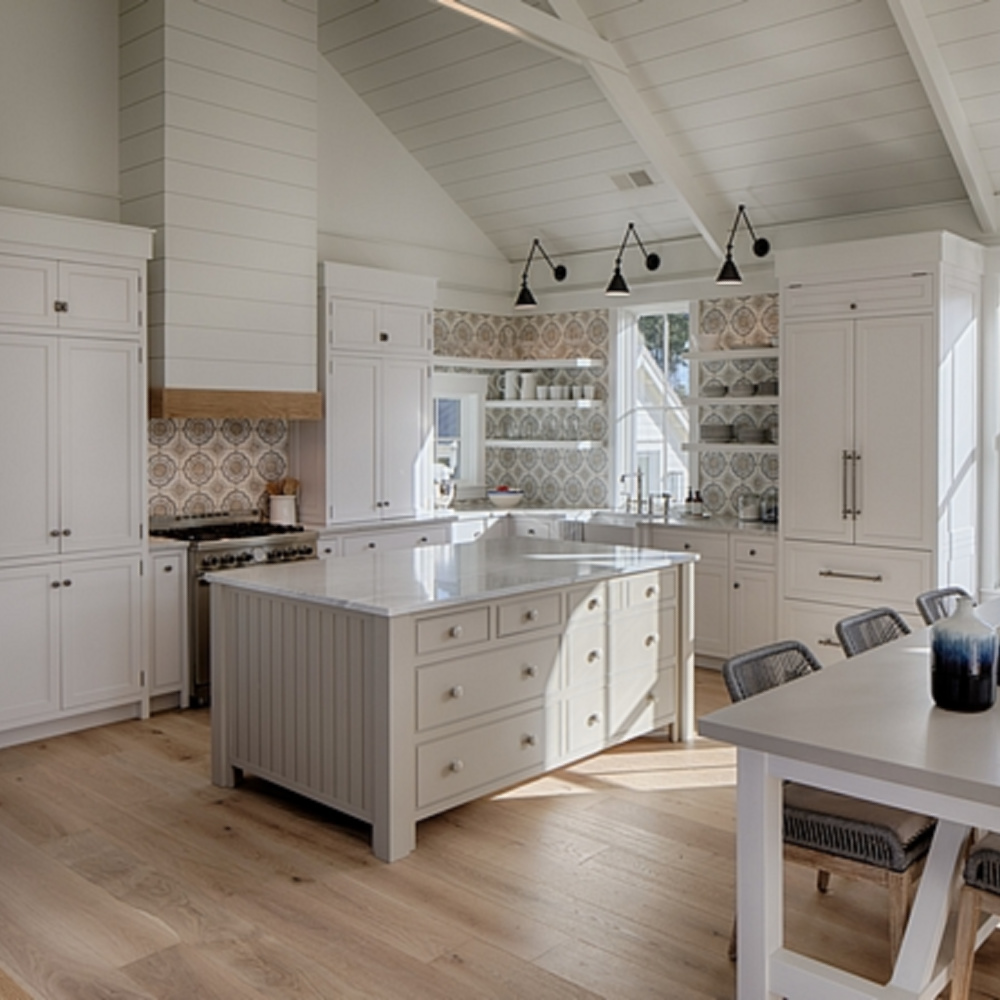 White coastal kitchen with modern farmhouse and Shaker designer elements. Lisa Furey created a welcoming home with shiplap, nods to coastal design, and blue accents. #coastalkitchen #modernfarmhousekitchen #kitchendesign #shiplap #shakerkitchen