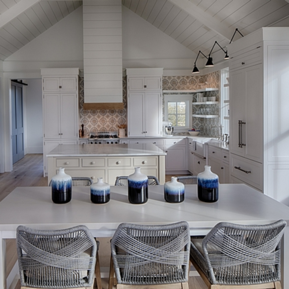 Coastal with modern farmhouse white kitchen in a board and batten coastal cottage in Palmetto Bluff. Lisa Furey designed this beautiful space. #coastalstyle #modernfarmhouse #kitchendesign #interiordesign