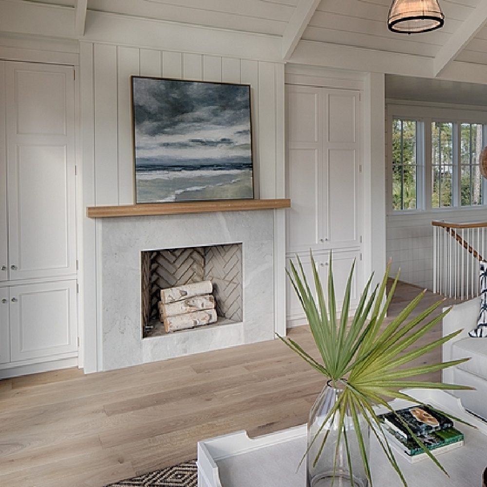 Fireplace in living room flanked by built-ins. Shiplap on walls and ceiling painted Benjamin Moore White. Designed by Lisa Furey. #coastalstyle #greatroom #fireplace #builtins #shiplap