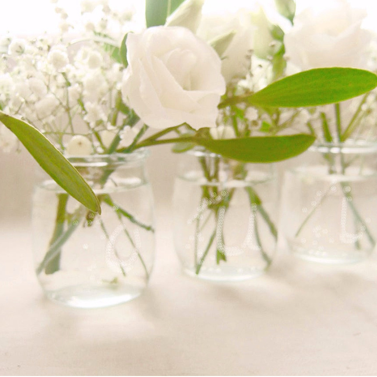 Simple French clear glass yogurt jars repurposed as vases for white blooms - FrenchHue on Etsy. #yogurtjars #vintagestye #vases