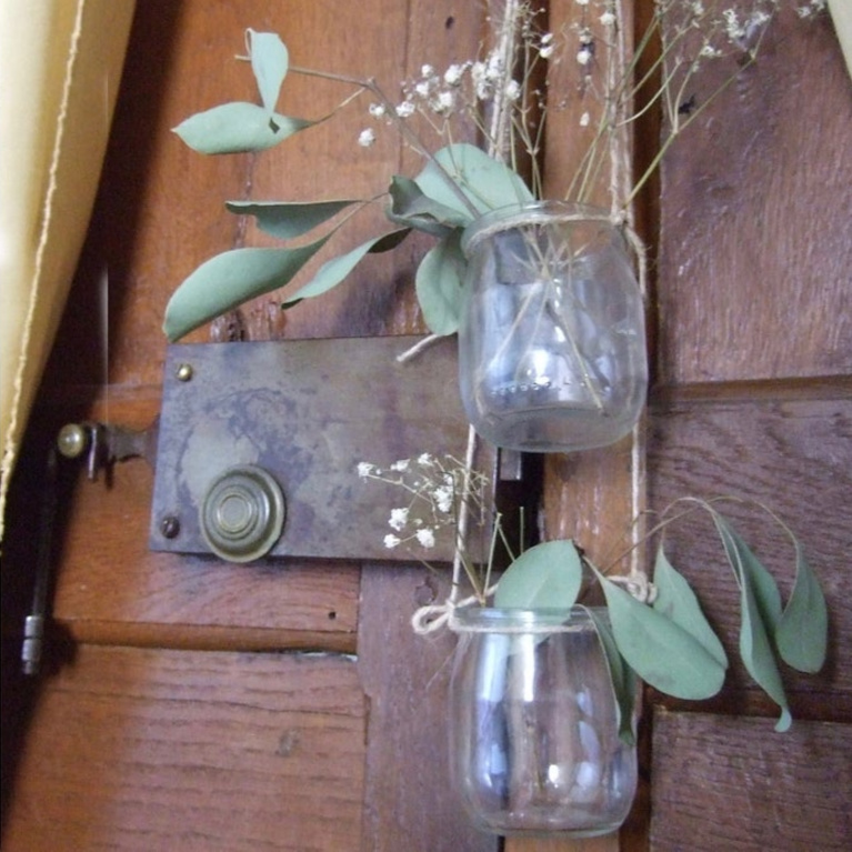 French yogurt jars recycled and repurosed as hanging vases on a vintage door - FrenchHue on Etsy. #frenchyogurt #yogurtjars