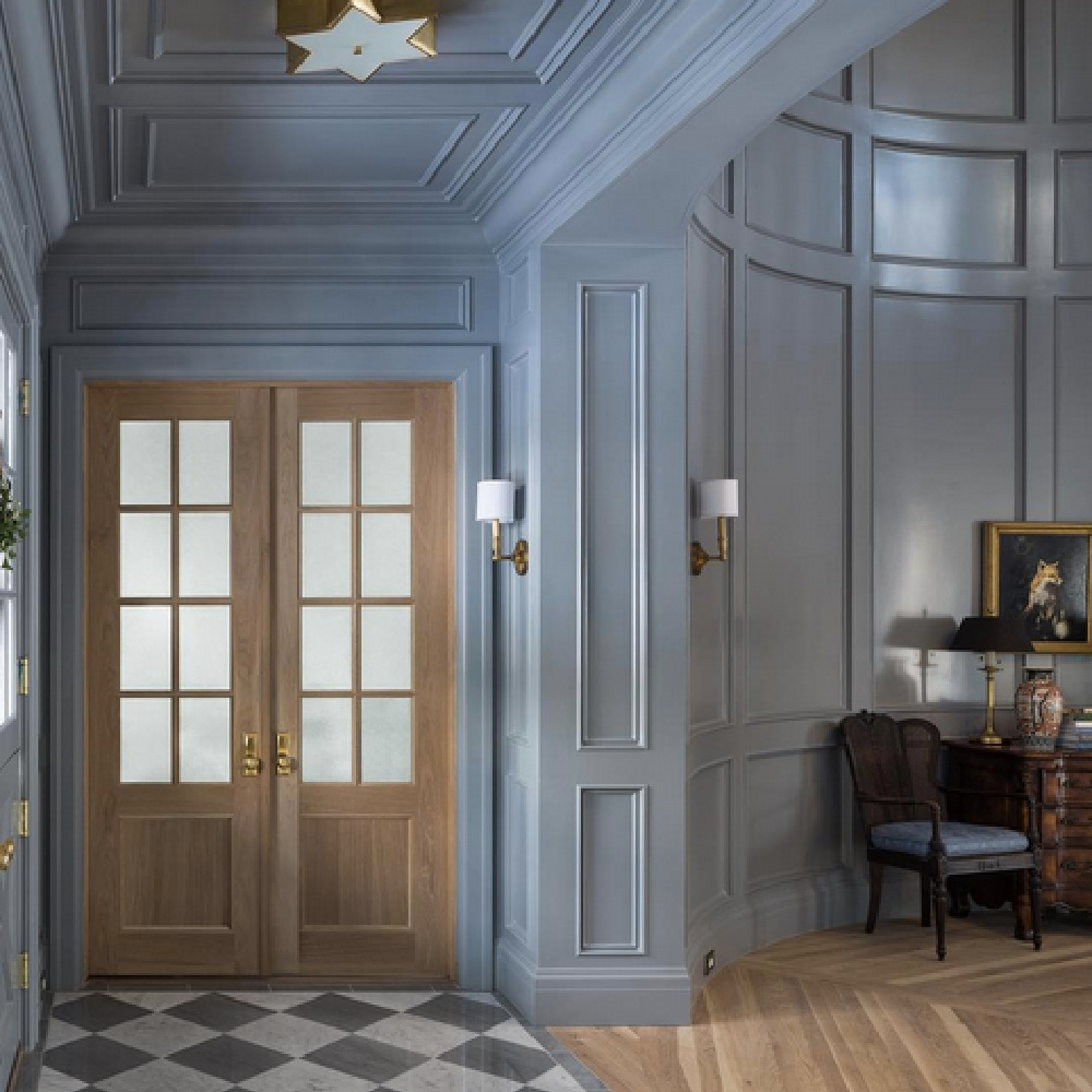 Blue grey painted paneled formal entry with checkered floor in magnificent house by The Fox Group. #bluegray #paneledroom #thefoxgroup #interiordesign #entry #traditional #millwork #architecture