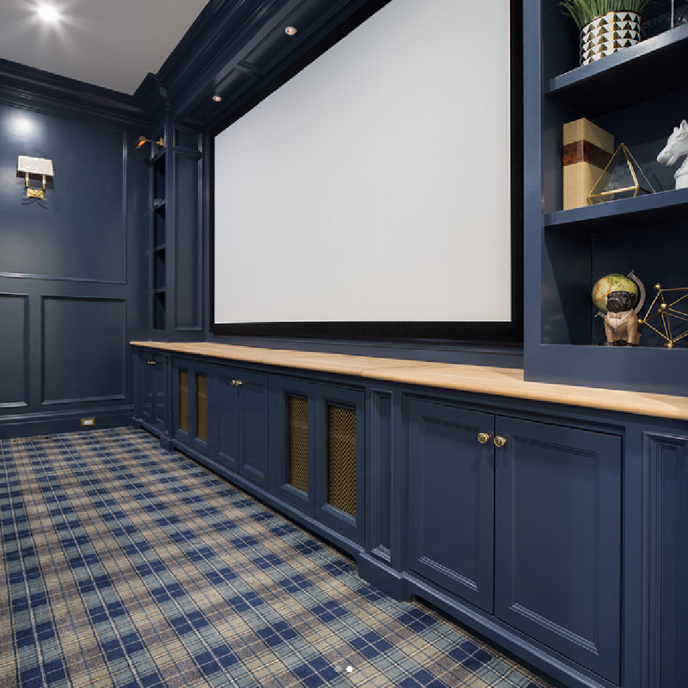 Navy blue painted paneled walls in a magificent media room with plaid carpet by The Fox Group. #navyblue #paneling #mediaroom #thefoxgroup #plaidcarpet