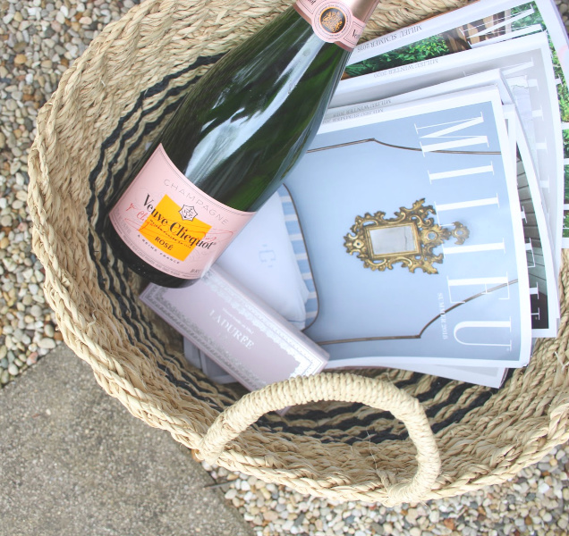 French seagrass baskets in the garden with copies of Milieu magazine and picnic essentials (champagne, macarons, and a Turkish beach blanket). #hellolovelystudio #milieumoment #seagrassbaskets #frenchbaskets #frenchpicnic #turkishtowel