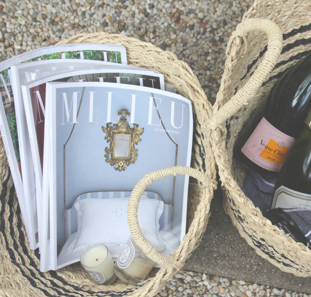 French seagrass baskets in the garden with copies of Milieu magazine and picnic essentials (champagne, Laduree macarons, and a Turkish beach blanket). #hellolovelystudio #milieumoment #seagrassbaskets #frenchbaskets #frenchpicnic #turkishtowel #laduree