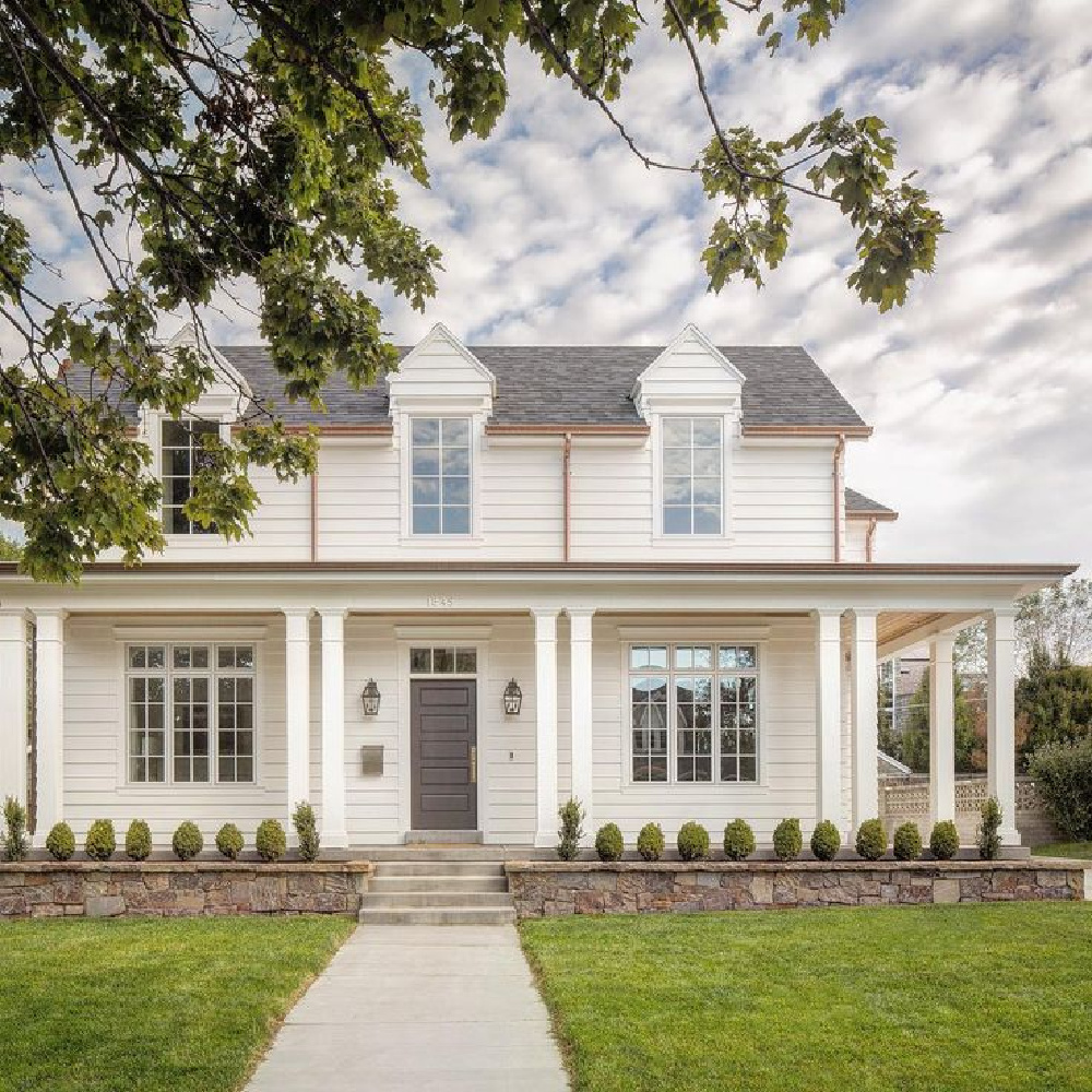 Charming traditional house construction by The Fox Group. Grey door with white siding. #thefoxgroup #houseconstruction #englishcountry #architecture