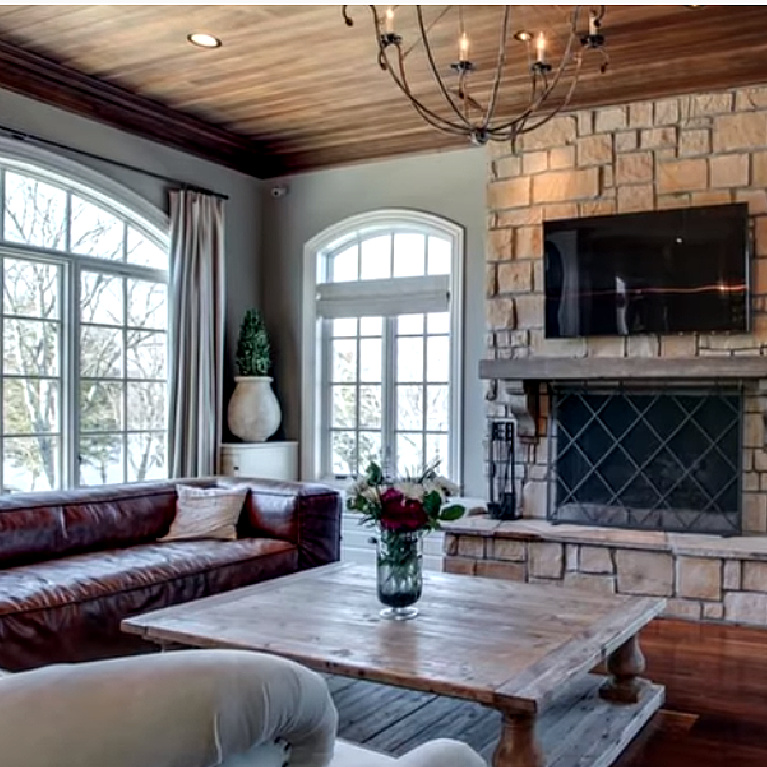 Kelly Clarkson home in Tennessee - a French country inspired den with stone and rustic wood ceiling.