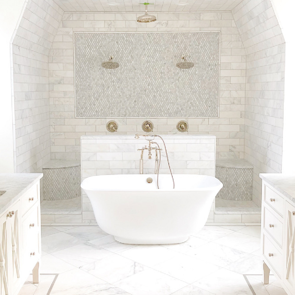 The Fox Group - luxurious white marble bath with double shower with his and hers built in benches. soaker tub, marble subway tile, and unique geometric open design. #bathroomdesign #luxurybathroom #subwaytile #doubleshower