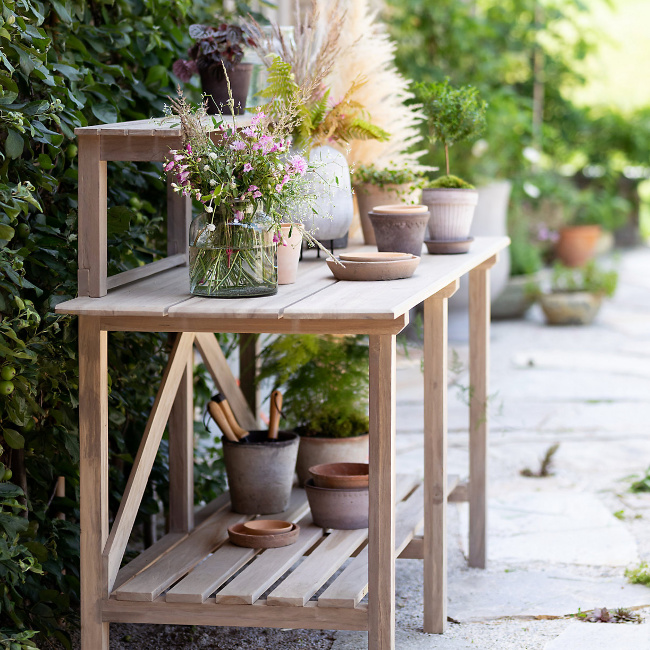 Potting bench with aged terracotta pots from Terrain. 