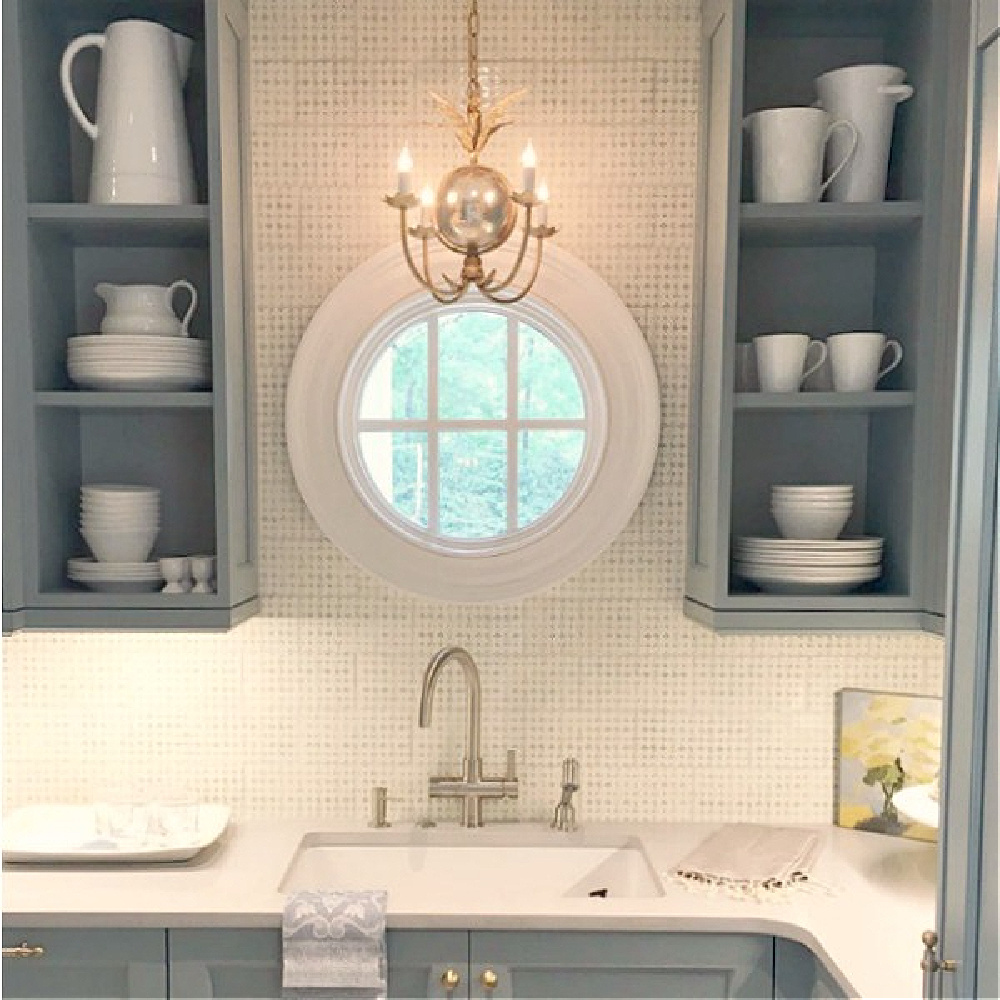 Elegant blue pantry with open shelves, round window, and handmade tile backsplash. Designed by Matthew Quinn and Lauren DeLoach for Atlanta Southeastern Designer Showhouse 2017. #bluekitchen #farrowandballlightblue #timelesskitchen #kitchendesign #traditionalkitchen