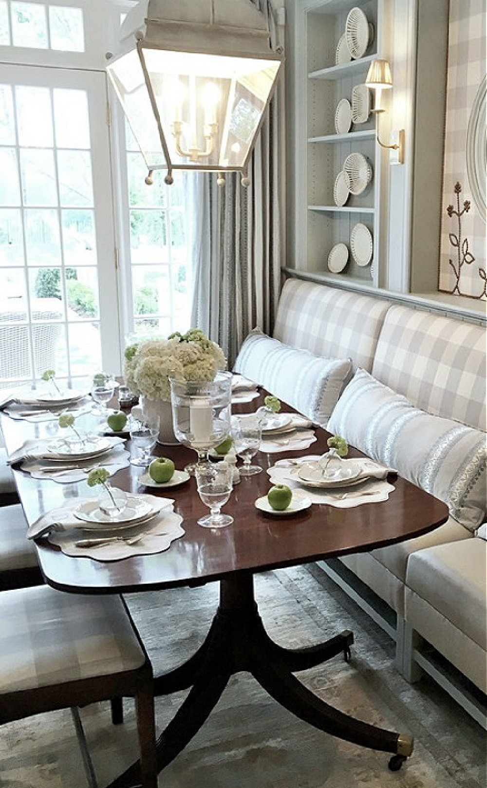 Farrow & Ball Light Blue painted cabinetry in a stunning traditional breakfast dining area in Atlanta. Design by Lauren DeLoach. Antiques and buffalo check fabric by Cowtan & Tout. #traditionalstyle #diningroom #interiordesign #lightblue