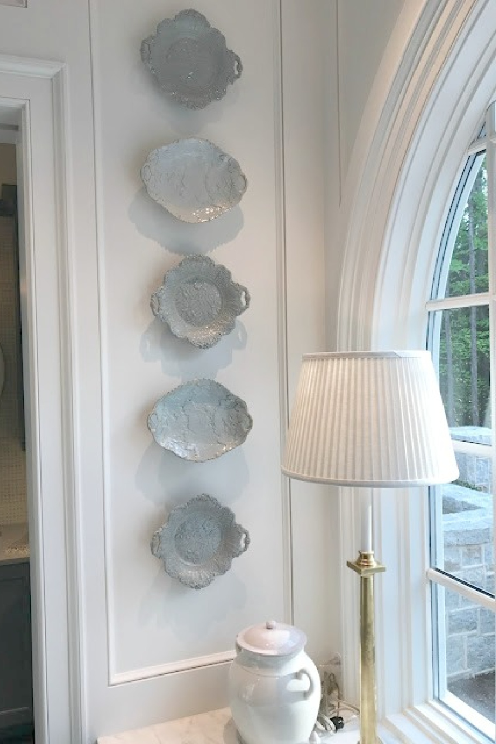 Antique Ridgeway china light blue plates hung on wall near farm sink in timeless kitchen of 2017 Southeastern Designer Showhouse.