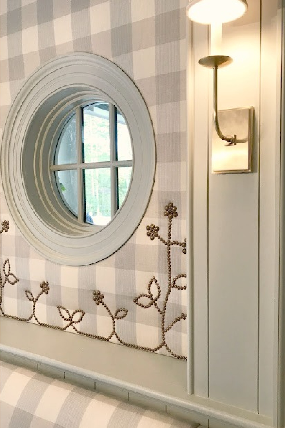 Nailhead detail on blue and white Buffalo check upholstered wall of a traditional dining room with wood painted Farrow & Ball Light Blue. #farrowandballlightblue #paintcolors #interiordesign #nailheadtrim #diningroom #timelessdesign #buffalocheck