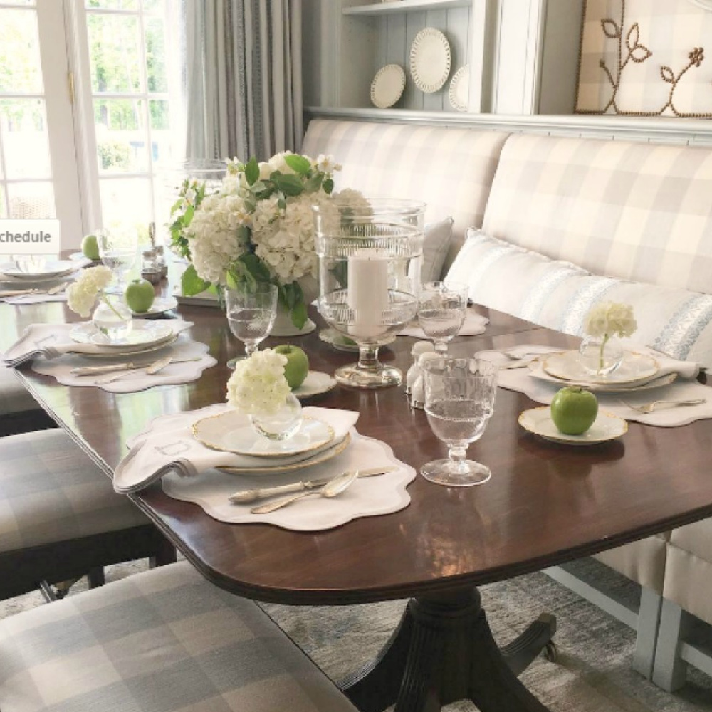 Blue and white Buffalo checks on banquette and vintage table in breakfast room of Southeastern Designer Showhouse 2017. #banquette #diningroom #interiordesign #buffalocheck #lightblue #traditionalstyle