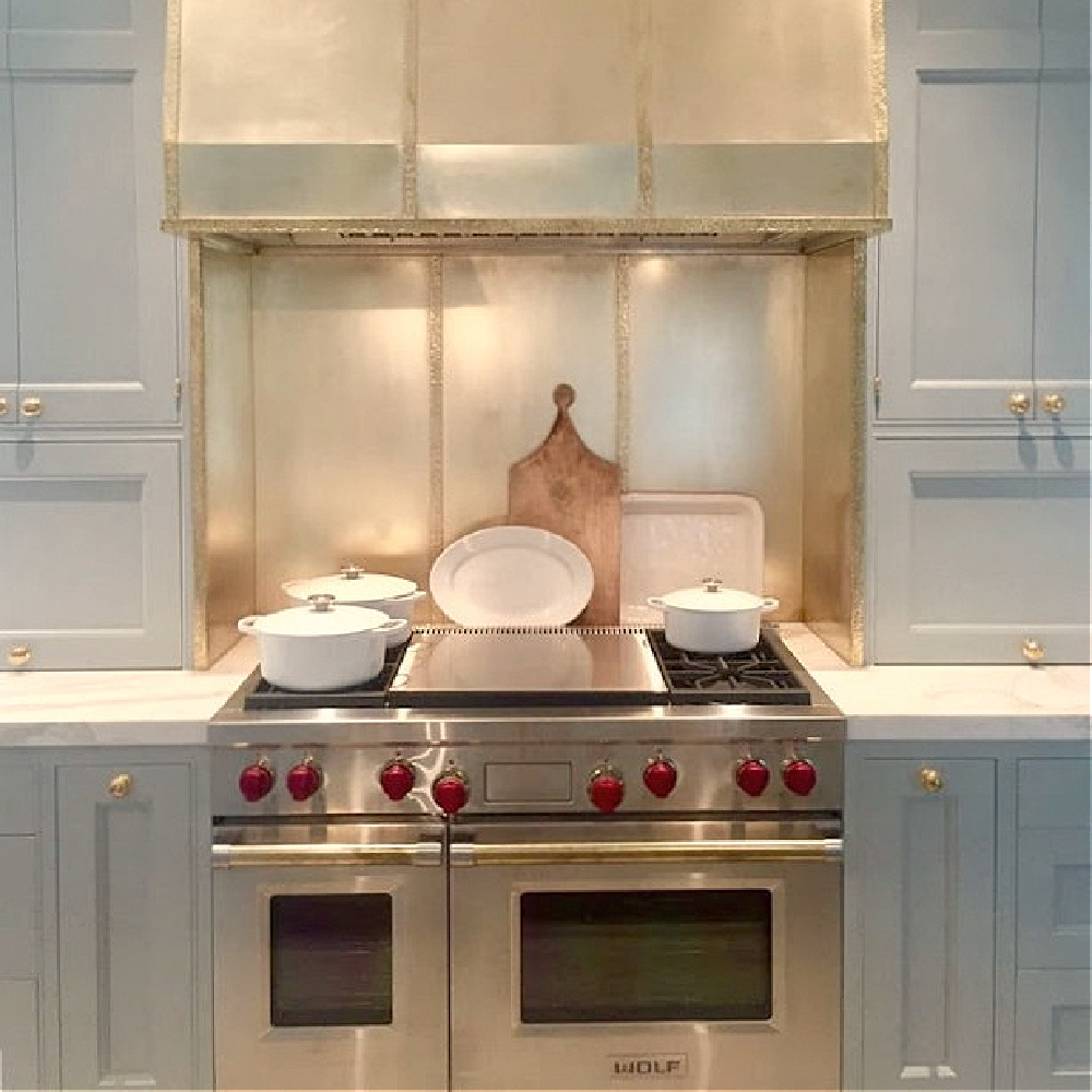 Brass range hood over Wolf range in kitchen in 2017 Southeastern Designer Showhouse in Atlanta. #bluekitchen #farrowandballlightblue #timelesskitchen #kitchendesign #traditionalkitchen