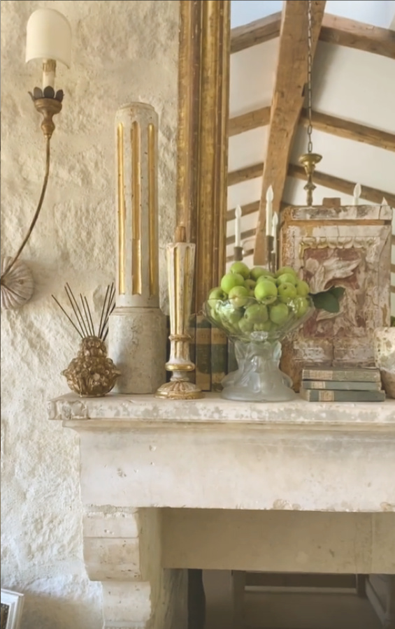 Beautiful antique French mantel and fireplace in Patina Farm's dining room - Velvet and Linen. #patinafarm #frenchfarmhouse #interiordesign #fireplace #giannetti
