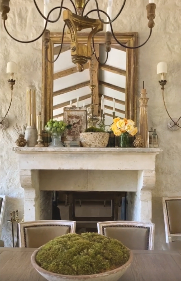 Beautiful antique French mantel and fireplace in Patina Farm's dining room - Velvet and Linen. #patinafarm #frenchfarmhouse #interiordesign #fireplace #giannetti