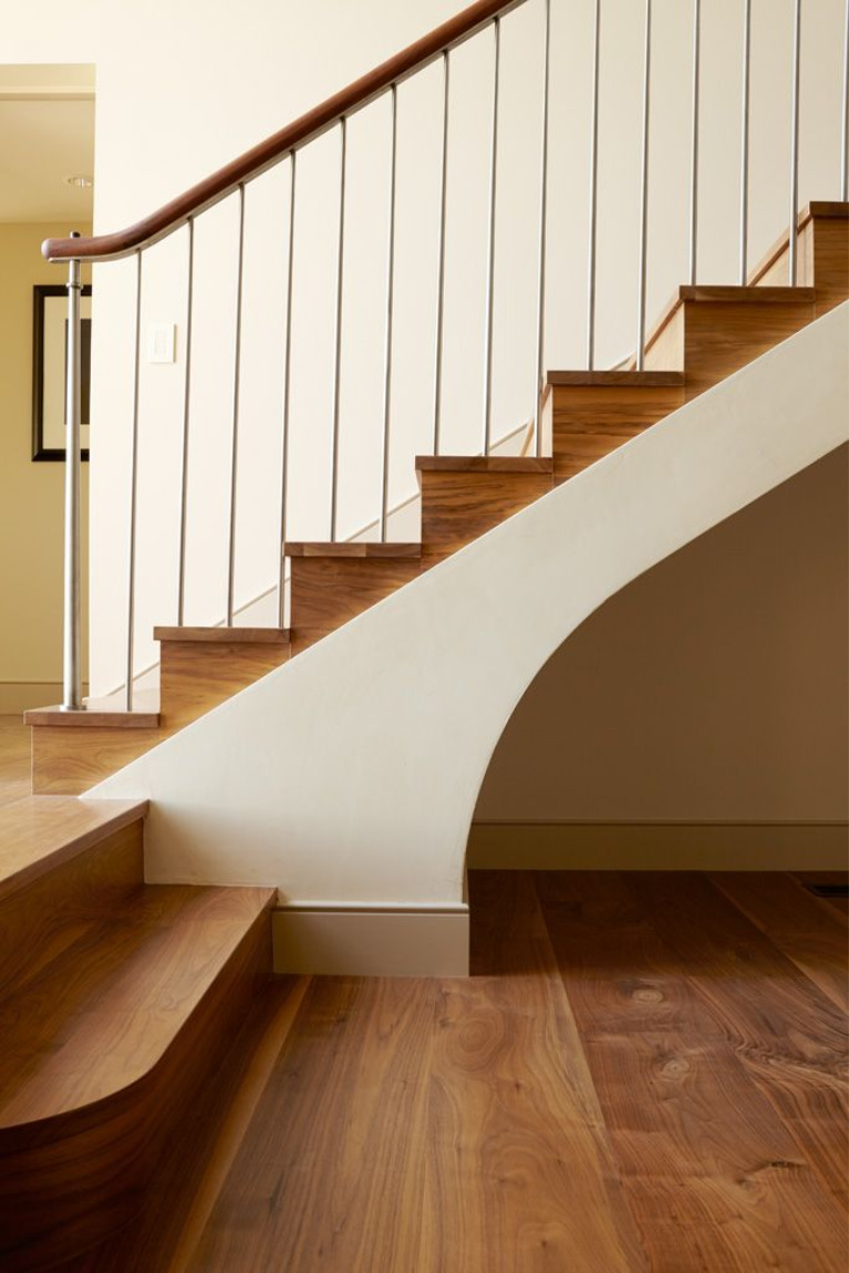 Magnificent architectural staircase with wide plank walnut hardwood by Carlisle. #flooring #staircase #hardwoodflooring #wideplankflooring #carlisle #walnutfloor #interiordesign