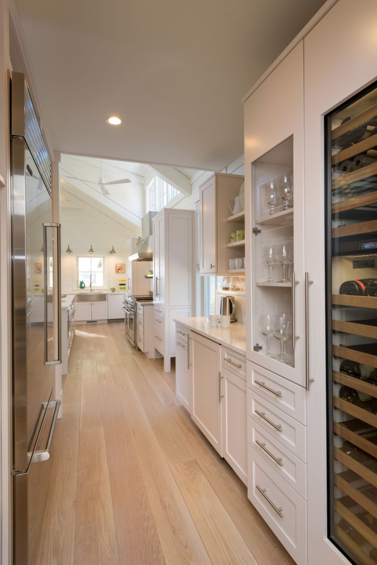 Prefinished White Oak wide plank flooring from Carlisle (Weekend Cottage) in a New Hampshire Kitchen with Shaker cabinets. #interiordesign #hardwoodfloors #whiteoak #wideplankflooring #carlisle #kitchendesign #coastalkitchen