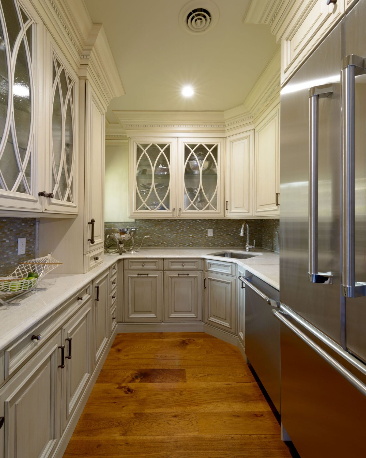 Warm hickory wide plank flooring (Carlisle) in a luxurious kitchen's butler pantry. #carlisle #flooring #hardwoodfloor #hickory #interiordesign #wideplankfloor