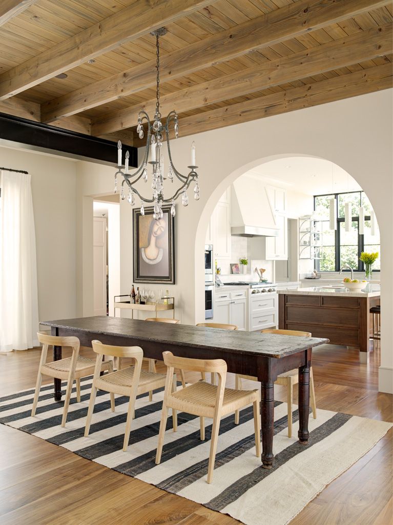 Walnut wood floor in a traditional dining room with eclectic decor. #hardwoodfloor #interiordesign #walnut #carlisle #wideplankflooring