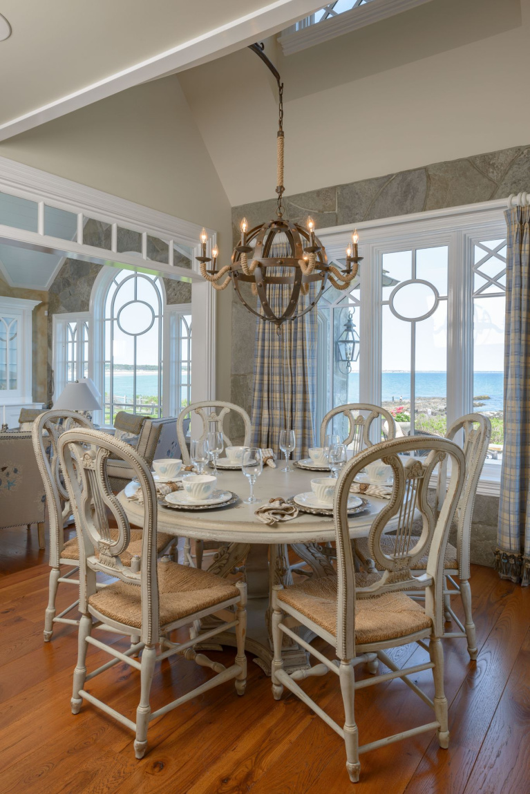 Hickory wide plank flooring in a coastal style dining room with French country decor, spectacular windows, and a majestic view. #flooring #wideplankflooring #hickory #hardwoodfloor #diningroom #coastalstyle #carlisle #interiordesign