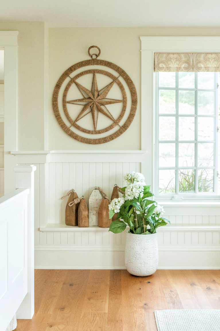 Rustic knots and character in white oak wide plank hardwood from Carlisle grace a coastal style space with beadboard and nautical decor. #woodflooring #wideplankflooring #hardwoodfloor #whiteoak #interiordesign