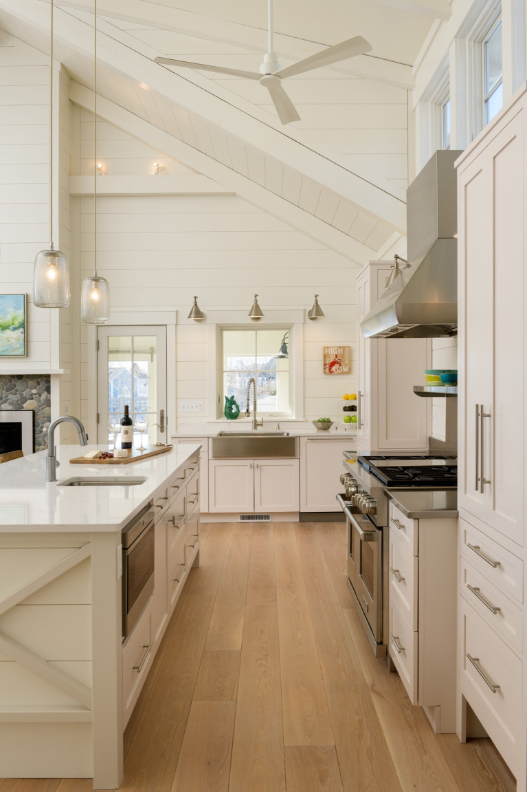 Prefinished White Oak wide plank flooring from Carlisle (Weekend Cottage) in a New Hampshire Kitchen with Shaker cabinets. #interiordesign #hardwoodfloors #whiteoak #wideplankflooring #carlisle #kitchendesign #coastalkitchen