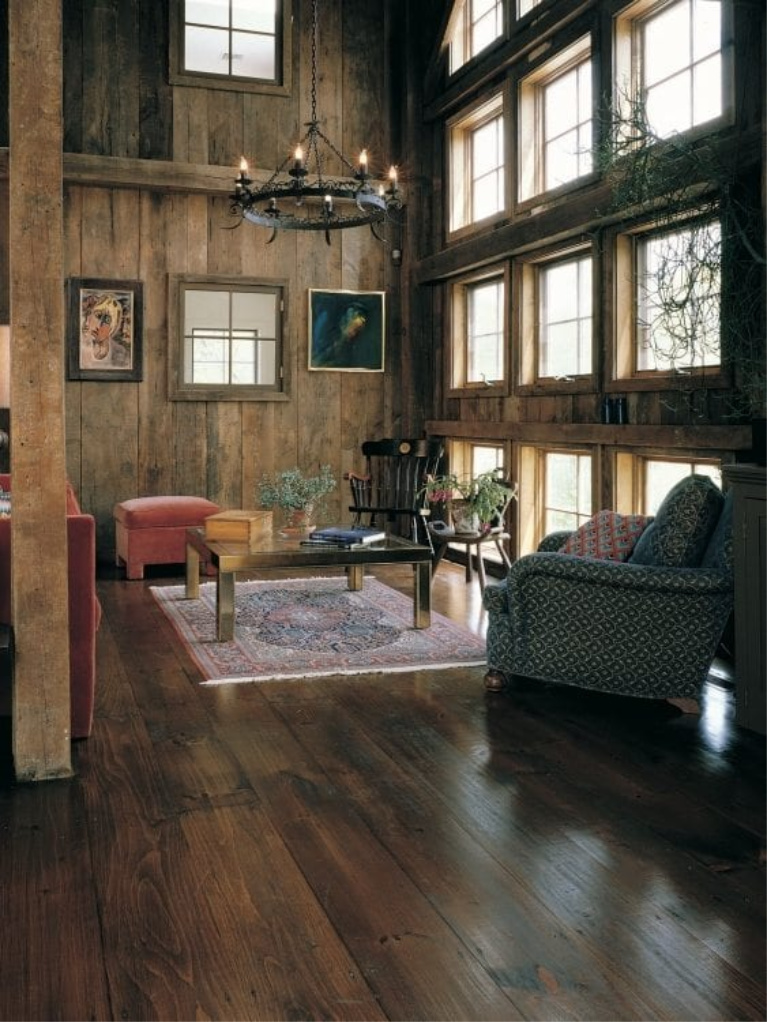 Reclaimed barnwood (Eastern Pine) wide plank flooring by Carlisle in a gorgeous living room with rustic decor. #flooring #hardwoodfloor #wideplankfloor #carlisle #livingroom #pinefloor #interiordesign