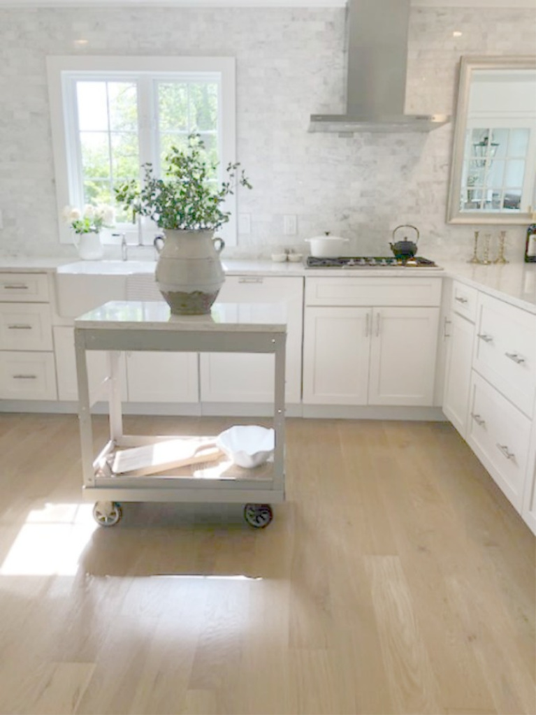 White oak hardwood floors in a serene simple Shaker modern farmhouse kitchen by Hello Lovely Studio. #hellolovelystudio #whiteoak #hardwoodfloors #kitchendesign #shakerkitchen