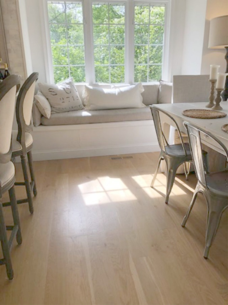 Hello Lovely Studio's serene kitchen with window seat has white oak hardwood floors. #hellolovelystudio #whiteoak #hardwoodfloors #kitchendesign #modernfarmhouse #windowseat