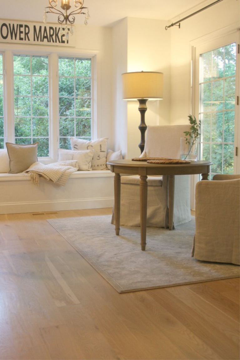 Hello Lovely Studio's serene kitchen with window seat has white oak hardwood floors. #hellolovelystudio #whiteoak #hardwoodfloors #kitchendesign #modernfarmhouse #windowseat