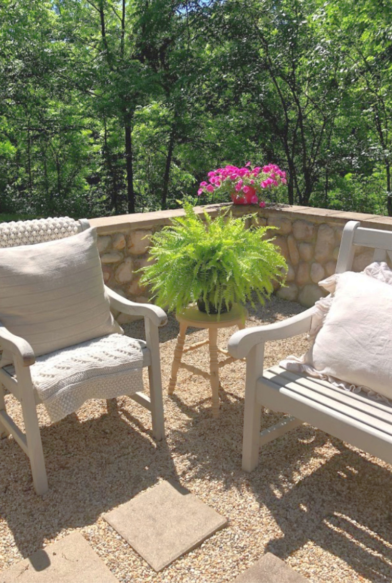 Airy and simple French inspired courtyard in summer with fern on a rustic wood farmhouse stool. #rusticstool #summergarden #hellolovelystudio