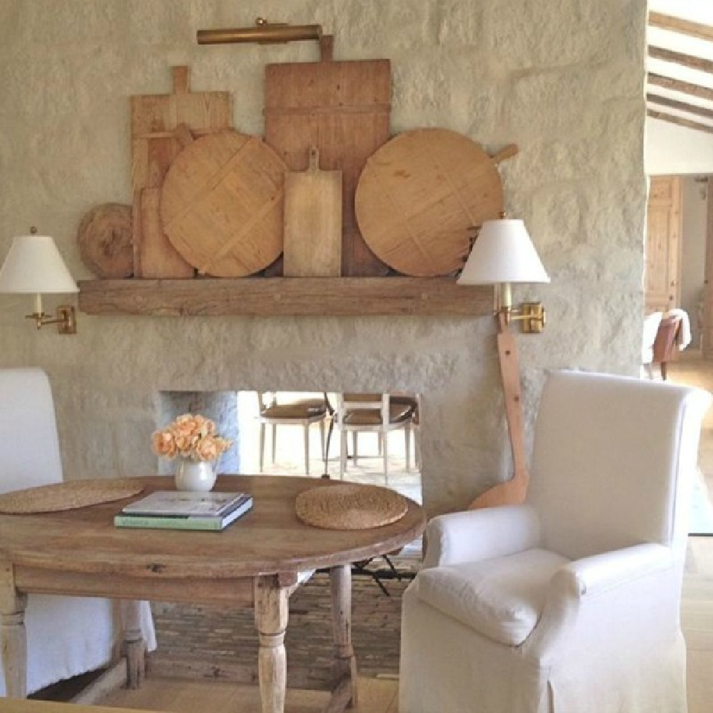 French farmhouse limestone fireplace and antiques in Patina Farm Kitchen - Giannetti Home. #frenchfarmhouse #fireplace #patinafarm #giannettihome #interiordesign #europeanfarmhouse #modernfarmhouse #limestone