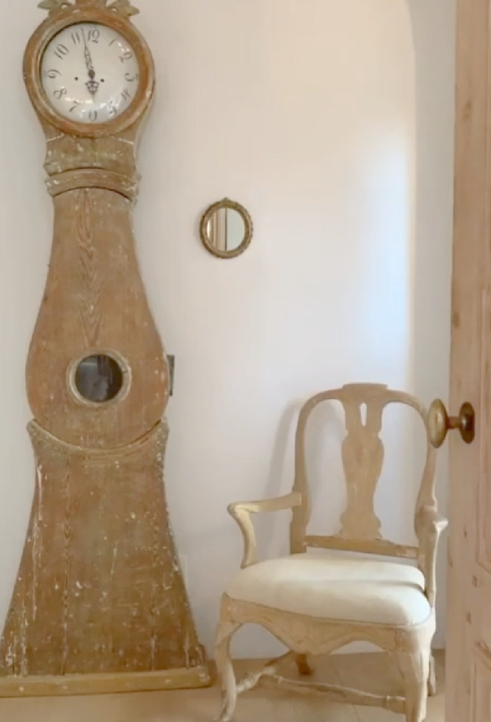 Swedish mora clock in romantic bedroom at Patina Farm (a European country farmhouse by Giannetti Home) with Old World style, sumptuous linens, a French stone fireplace, and rustic elegant charm. #moraclock #interiordesign #swedishantiques #europeancountry #frenchfarmhouse #patinafarm #brookegiannetti