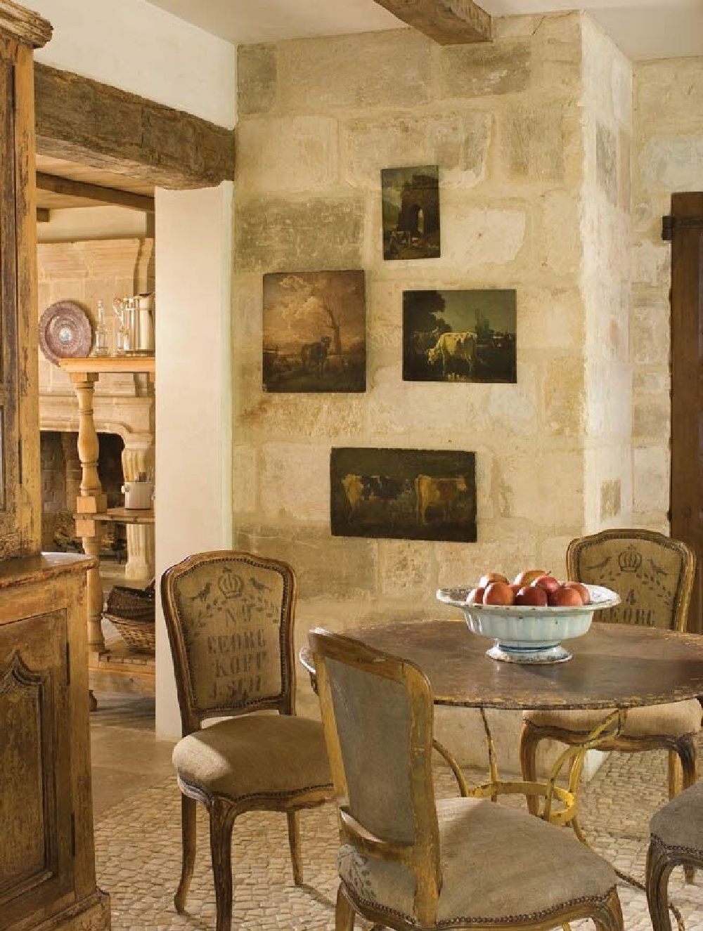 Pale tone on tone palette with reclaimed limestone walls and floors in a modern French breakfast dining room (Chateau Domingue). #oldworldstyle #europeancountry #modernfrench #frenchfarmhouse