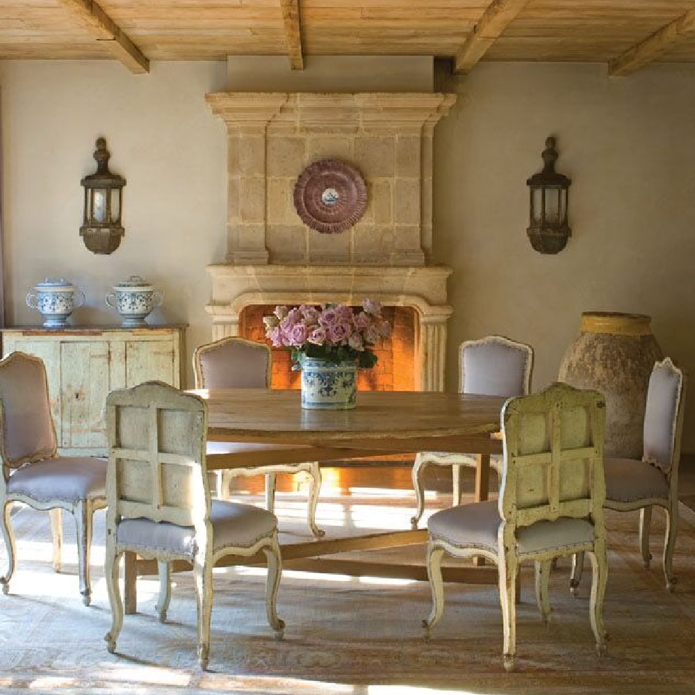 Elegant rustic French country dining room with antiques, reclaimed stone, and treasures from Chateau Dominuge including limestone fireplace - Milieu. #oldworldstyle #diningroom #countryfrench #frenchfarmhouse #diningrooms
