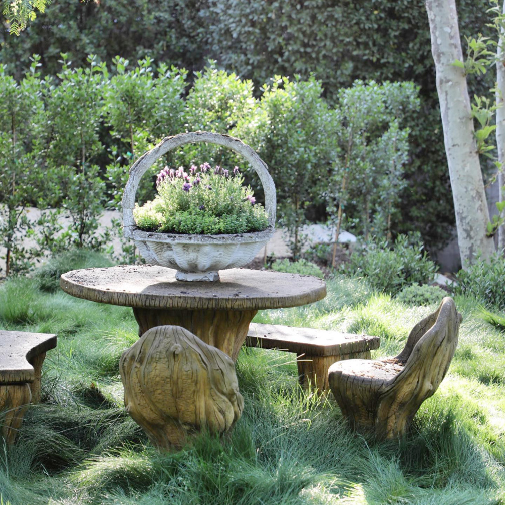 Charming and rustic outdoor dining area with potted flowers at Patina Farm - Brooke Giannetti of VelvetandLinen.