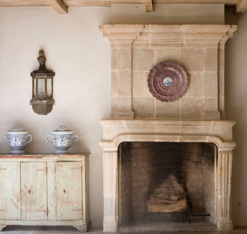 Magnificent antique French limestone fireplace and European country treasures from Chateau Domingue in the exquisite home of Ruth Gay.