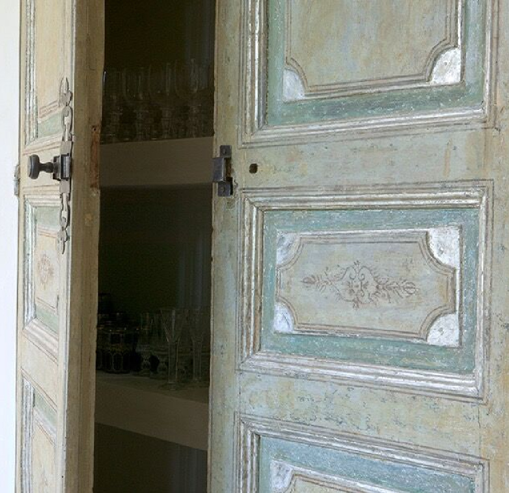 Beautiful painted antique French wood doors in the home of Ruth Gay - Chateau Domingue. #oldworldstyle #antiquedoors #frenchdoors