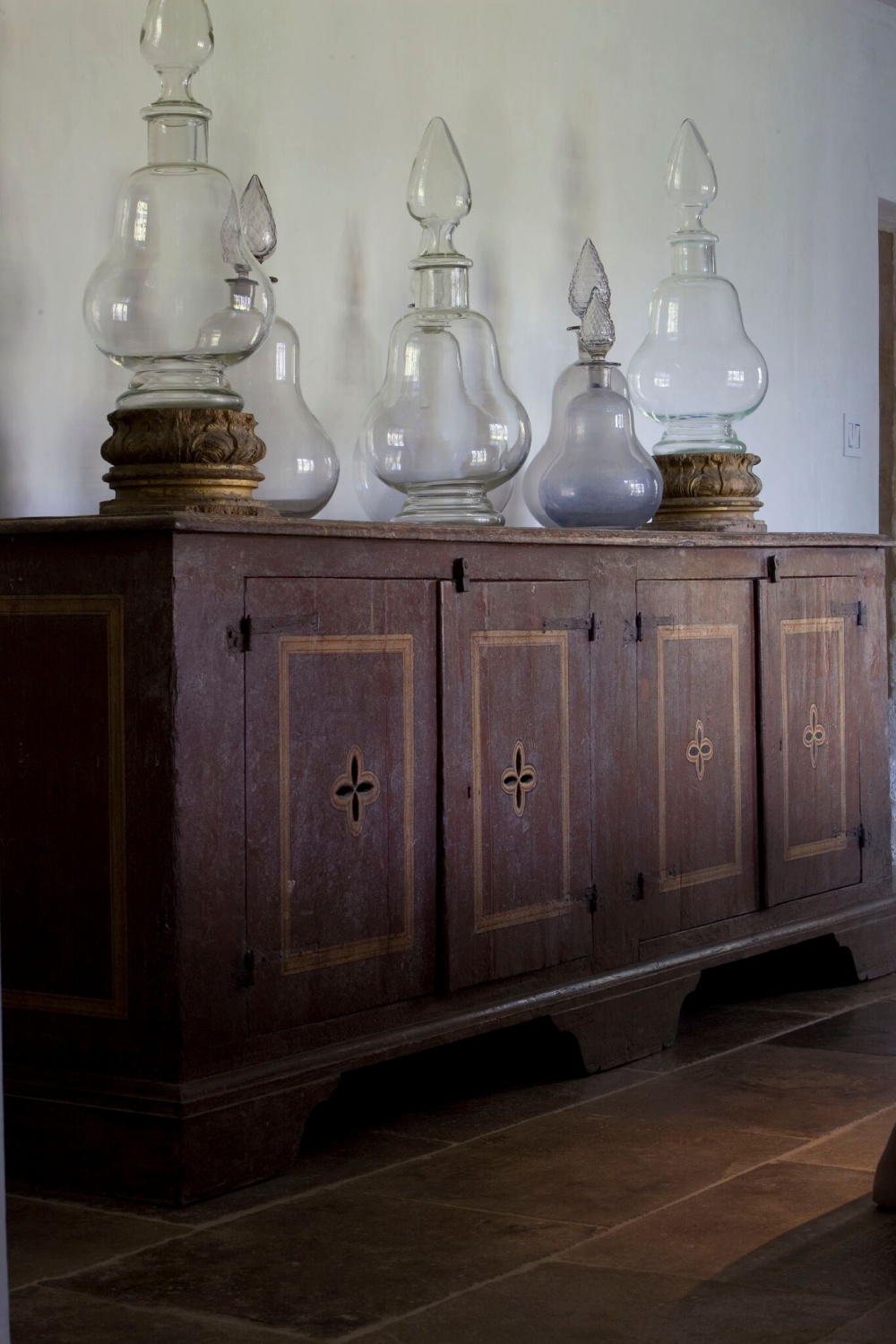 Magnificent antique rustic wood sideboard and treasures from Europe in Ruth Gay's elegant dining room (Chateau Domingue).