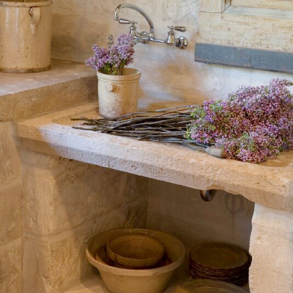 Warm rugged antique stone sink in a beautiful country French kitchen - Chateau Domingue.