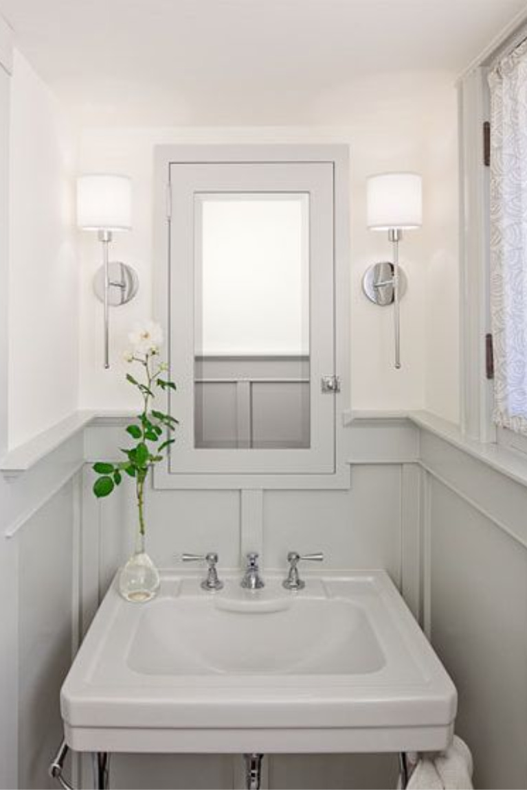 Seapearl by Benjamin Moore is the white color above the paneled wainscot in this powder room while Stonington Gray is the paint color on trim. #powderroom #paintcolors #benjaminmooreseapearl #benjaminmoorestoningtongray #seapearl #stoningtongray