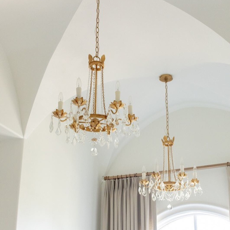 Elegant gold toned French country crystal chandeliers (Troy Viola) in a bathroom design by Brit Jones. #frenchcountry #interiordesign #bathroomdesign #chandeliers #romanticdecor