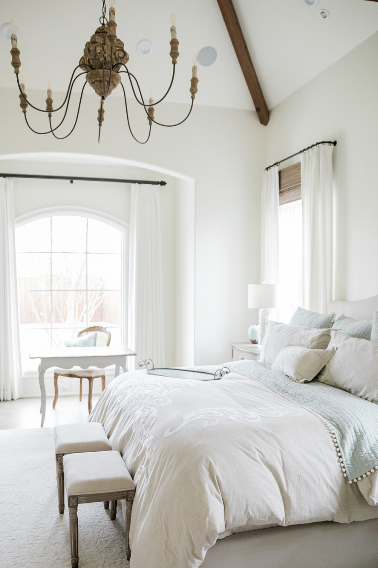 French country bedroom with pastel blue and white and carved wood Old World chandelier - Brit Jones. #interiordesign #bedroomdecor #frenchcountry #romanticdecor #pastelbedroom #lightblue
