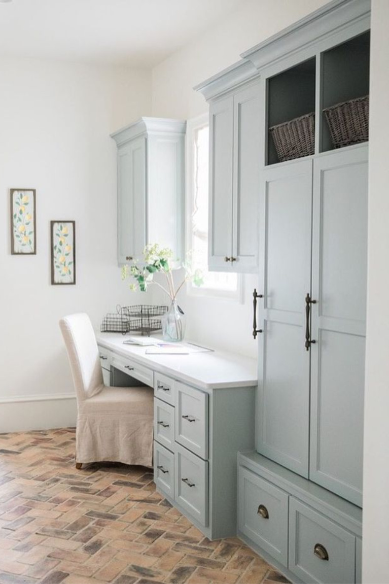 Silver  Mist (Sherwin Williams) paint color on cabinets in a lovely French country laundry room mud room by Brit Jones Design. #laundryroom #frenchcountry #brickflooring #herringbone #bluegrey #silvermist #sherwinwilliamssilvermist #paintcolors