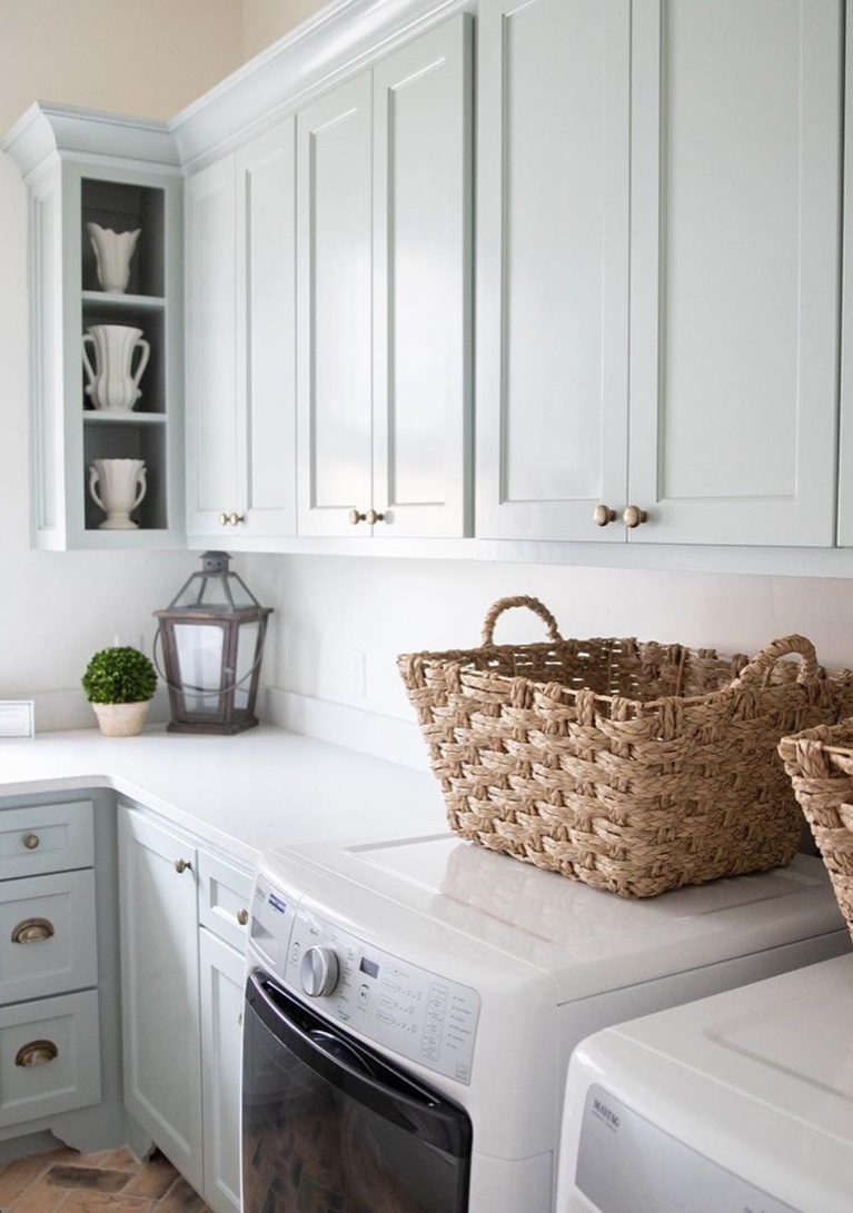 Silver Mist paint color on cabinets in a lovely French country laundry room mud room by Brit Jones Design. #laundryroom #frenchcountry #brickflooring #herringbone #bluegrey #silvermist #paintcolors