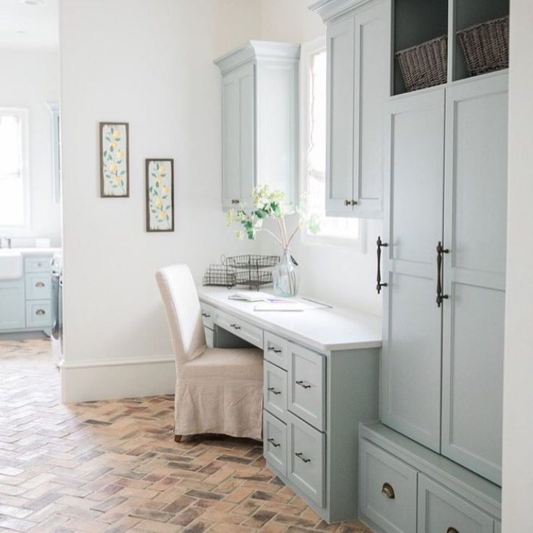 Silver Mist (Sherwin Williams) paint color on cabinets in a lovely French country laundry room mud room by Brit Jones Design. #laundryroom #frenchcountry #brickflooring #herringbone #bluegrey #silvermist #sherwinwilliamssilvermist #paintcolors